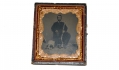 SIXTH PLATE TINTYPE OF MAN HOLDING A RIFLE WITH SLEEPING DOG