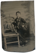 TINTYPE OF YOUNG BOY WITH RIFLE
