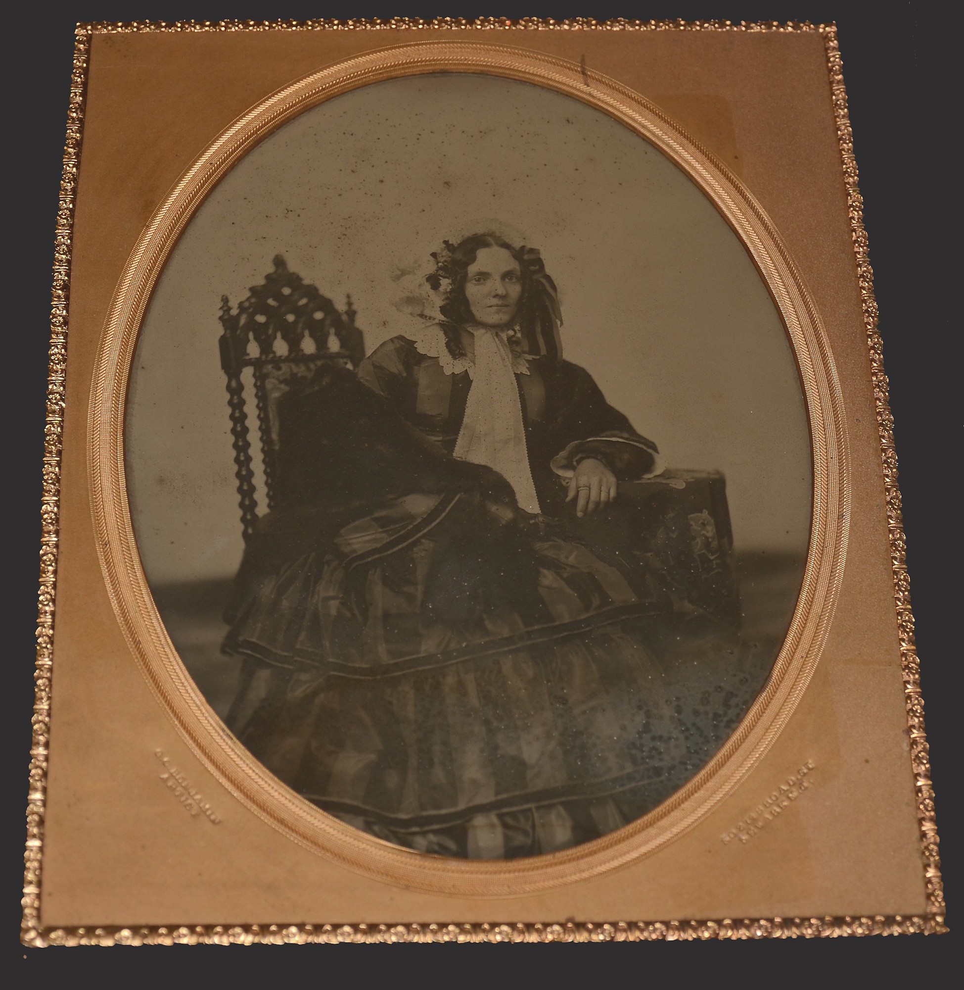 MAGNIFICENT FULL PLATE AMBROTYPE, IN FINE DOUBLE-SIDED BRASS MOUNTED PLATE, FEATURING WOMAN IN FULL CRINOLINE