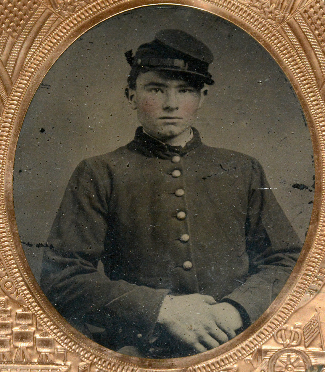 SIXTH PLATE TINTYPE OF A YOUNG UNION SOLDIER WITH PATRIOTIC MAT