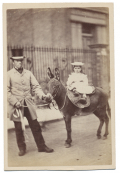 CDV OF BLACK ENGLISHMAN WALKING DONKEY WITH WHITE CHILD RIDER