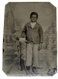 EIGHTH-PLATE TINTYPE OF A BAREFOOT YOUNG CHILD OF AFRICAN DESCENT 