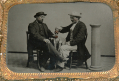 QUARTER-PLATE TINTYPE OF TWO MEN SHARING A BOTTLE OF “RED EYE”