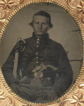 NINTH-PLATE TINTYPE OF A SEATED UNION CAVALRYMAN WITH A COLT REVOLVER STUCK IN HIS BELT