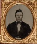 NINTH PLATE AMBROTYPE OF A YOUNG MAN IN A VERY NICE UNION CASE WITH A USS MONITOR MOTIF