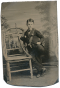 TINTYPE OF YOUNG BOY WITH RIFLE