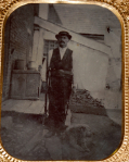 QUARTER PLATE TINTYPE OF MAN HOLDING A RIFLE, WITH DOG