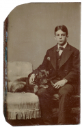 TINTYPE OF A YOUNG MAN WITH A BLACK DOG