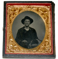SIXTH PLATE TINTYPE OF MAN WITH DOG ON HIS LAP