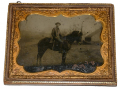 HALF PLATE TINTYPE OF AN OUTDOOR VIEW FEATURING AN UNIDENTIFIED MOUNTED CAVALRYMAN & HIS STEED 