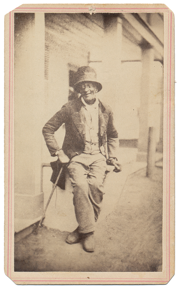 OUTDOOR VIEW OF AN ELDERLY BLACK MAN IN TOP HAT AND TAILS – INTERESTING INSCRIPTION ON REVERSE