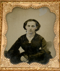 SIXTH PLATE AMBROTYPE OF A YOUNG WOMAN HOLDING A CASED PHOTOGRAPH 