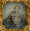 SIXTH PLATE AMBROTYPE OF A SEATED SOUTH CAROLINA CONFEDERATE SOLDIER DISPLAYING A PHOTOGRAPHIC CASE FOR THE CAMERA