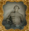 SIXTH PLATE AMBROTYPE OF A SEATED SOUTH CAROLINA CONFEDERATE SOLDIER DISPLAYING A PHOTOGRAPHIC CASE FOR THE CAMERA