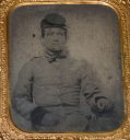 SIXTH PLATE TINTYPE OF A SEATED CONFEDERATE SOLDIER WITH FORAGE CAP