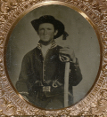 TINTYPE OF A TRIPLE ARMED UNION CAVALRYMAN IN A PATRIOTIC CASE