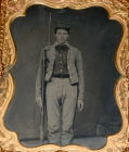 FANTASTIC QUARTER-PLATE TINTYPE OF YOUNG ARMED CONFEDERATE SOLDIER