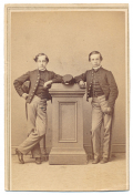 FULL STANDING VIEW OF A PAIR OF NAMED YOUNG CADETS TRYING TO LOOK OLDER AND TOUGHER THAN THEIR YEARS  