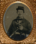 NINTH-PLATE AMBROTYPE OF SEATED SOLDIER WITH REVOLVER AND SIDE-KNIFE
