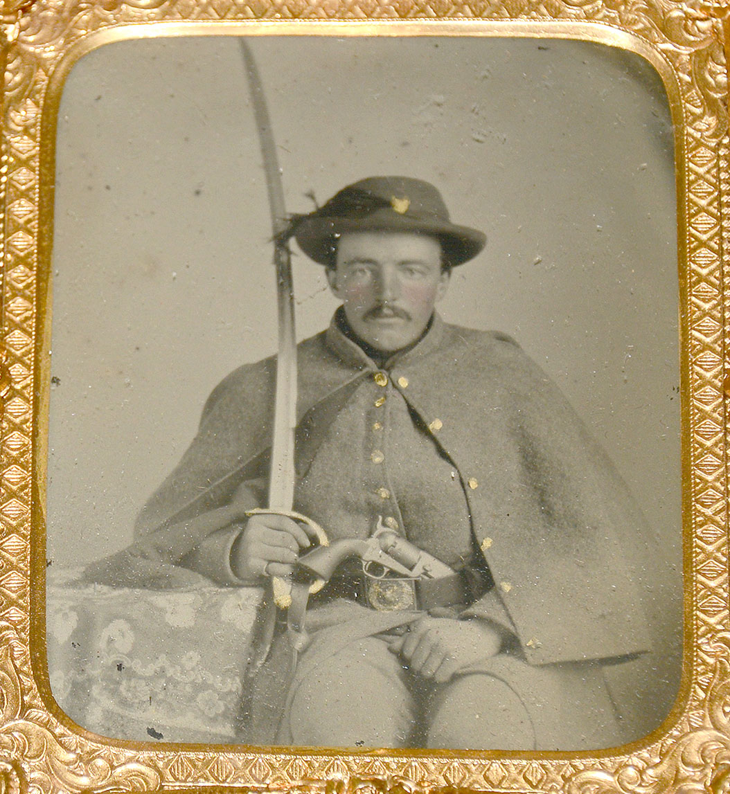 CASED 1/6 PLATE TINTYPE OF CAVALRYMAN WITH SWORD AND REVOLVER
