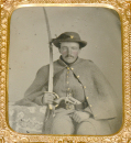 CASED 1/6 PLATE TINTYPE OF CAVALRYMAN WITH SWORD AND REVOLVER