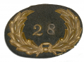 FALSE EMBROIDERED 28th REGIMENT, POST, OR STATION HAT INSIGNIA