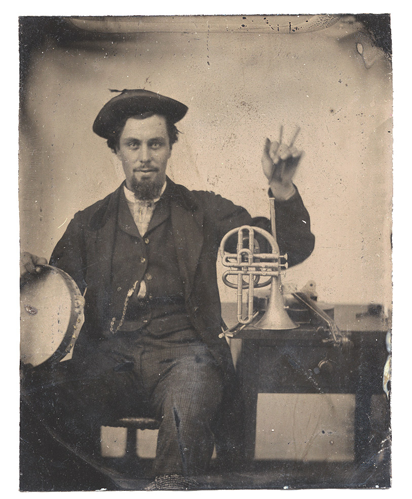 TINTYPE PORTRAIT OF A MUSICIAN WITH TAMBOURINE AND BRASS HORN 
