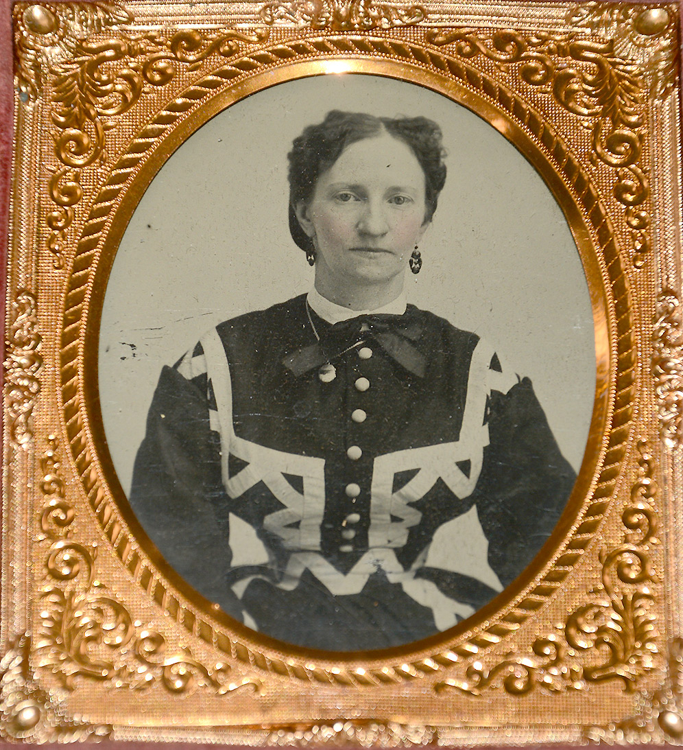 CASED TINTYPE OF WOMAN IN FANCY DRESS AND TINY WAIST